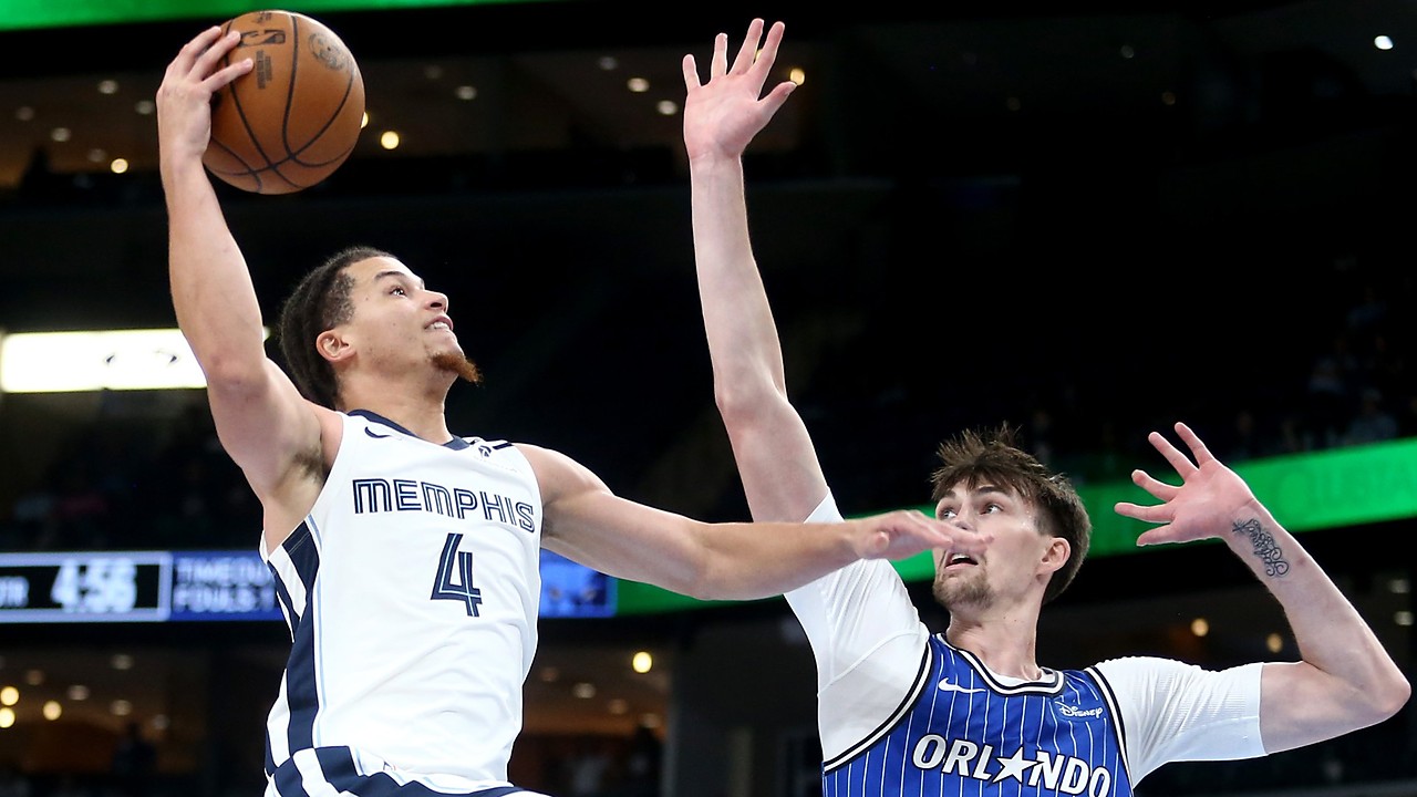 Memphis Grizzlies guard Walter Clayton Jr. rises for a one-handed layup as Orlando Magic center Colin Castleton reaches to contest.