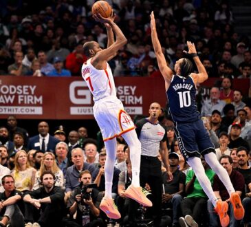 Mavericks forward Zaccharie Risacher leaps to contest a jump shot by Rockets forward Kevin Durant.