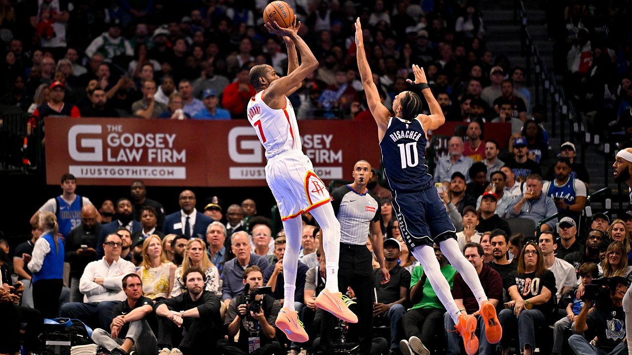 Mavericks forward Zaccharie Risacher leaps to contest a jump shot by Rockets forward Kevin Durant.
