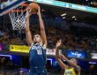 Dallas Mavericks forward Zaccharie Risacher dunks with both hands as Indiana Pacers guard Aaron Nesmith leaps to contest.