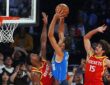 Mavericks forward Zaccharie Risacher rises for a shot over Rockets guard Marcus Smart as another Rockets defender contests.