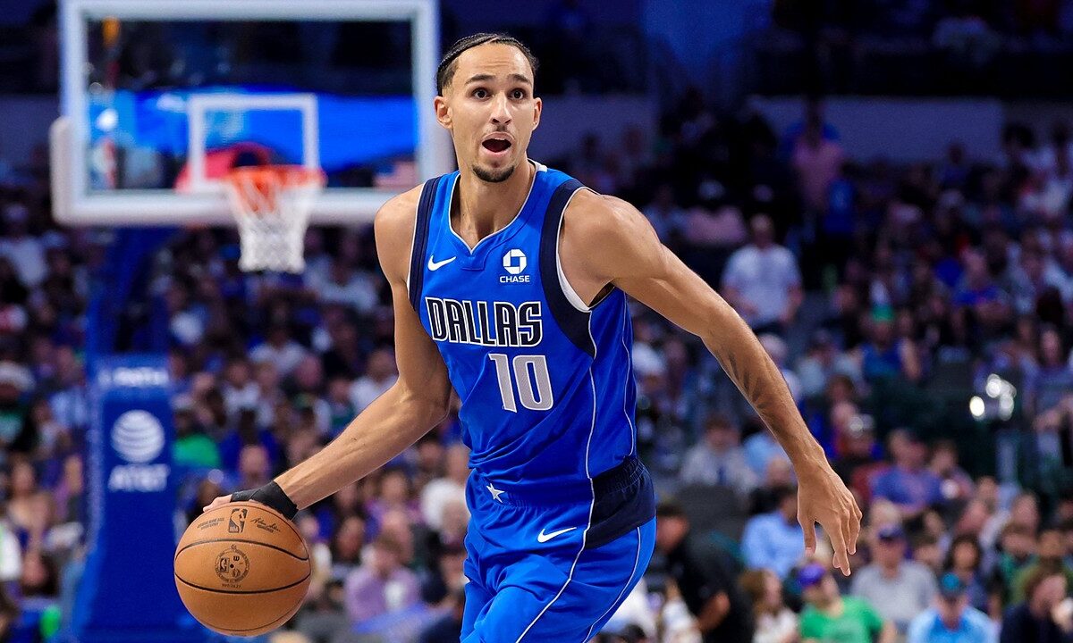 Dallas Mavericks forward Zaccharie Risacher dribbles up the court with his left hand in a blue Dallas No. 10 jersey.