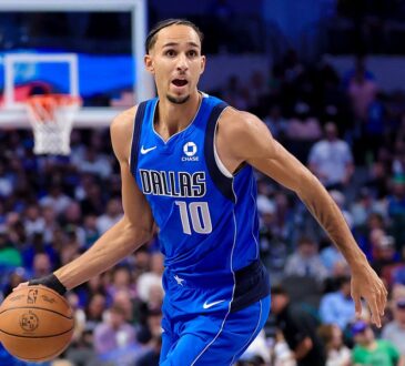 Dallas Mavericks forward Zaccharie Risacher dribbles up the court with his left hand in a blue Dallas No. 10 jersey.