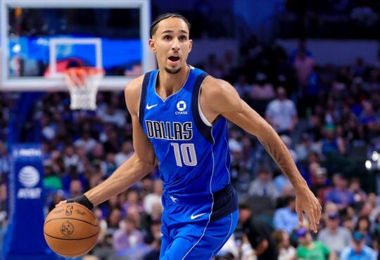 Dallas Mavericks forward Zaccharie Risacher dribbles up the court with his left hand in a blue Dallas No. 10 jersey.