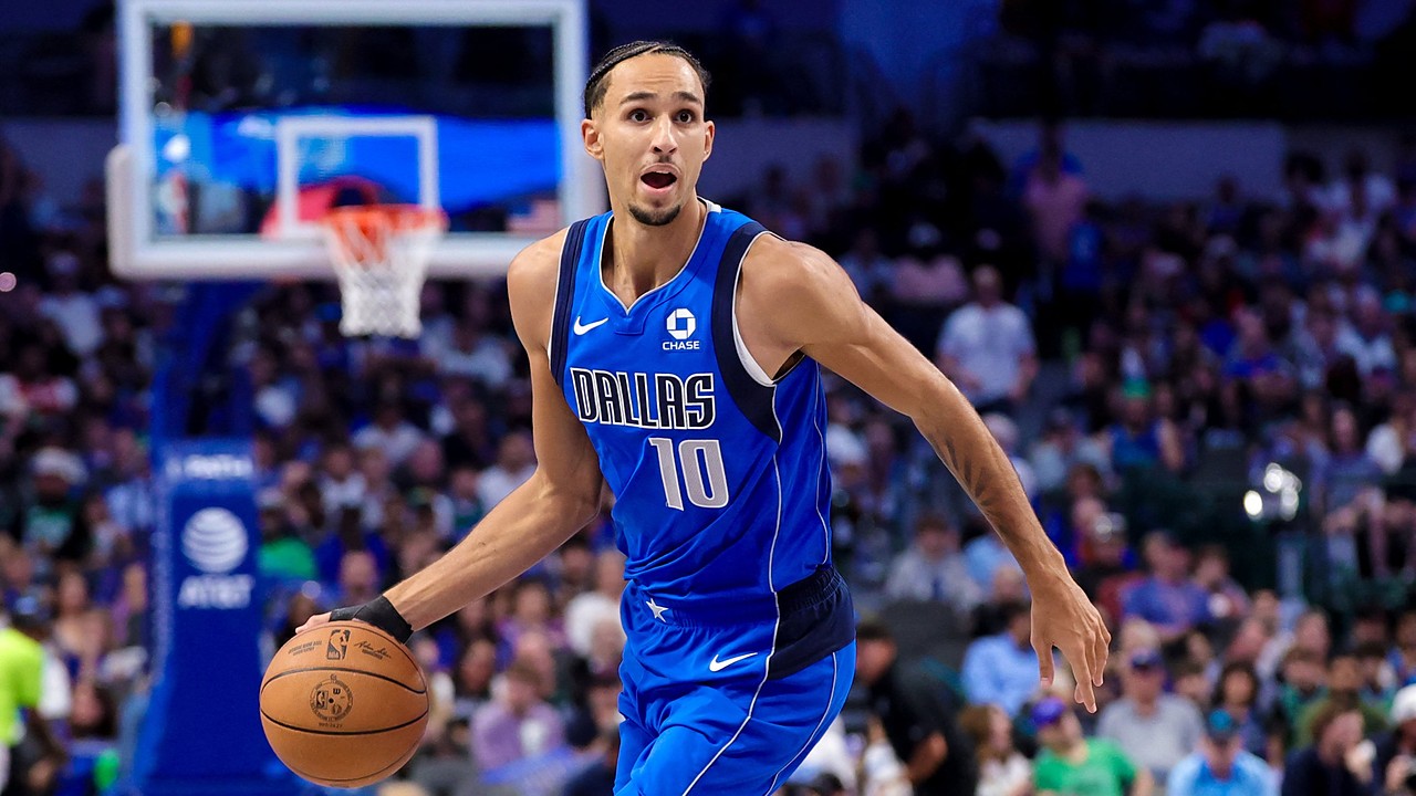 Dallas Mavericks forward Zaccharie Risacher dribbles up the court with his left hand in a blue Dallas No. 10 jersey.